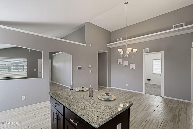 401 Gran Villa Pl, Socorro, TX 79927 - kitchen featuring a chandelier, high vaulted ceiling, baseboards, light stone countertops, and open floor plan