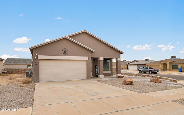 401 Gran Villa Pl, Socorro, TX 79927 - view of front of house featuring stucco siding, central AC unit, concrete driveway, and a garage