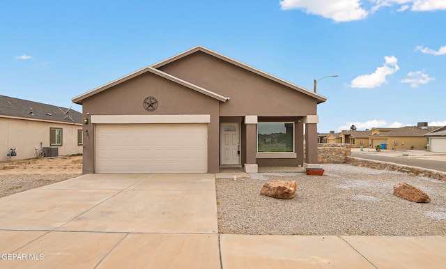 401 Gran Villa Pl, Socorro, TX 79927 - view of front of property with central air condition unit, stucco siding, a garage, and concrete driveway
