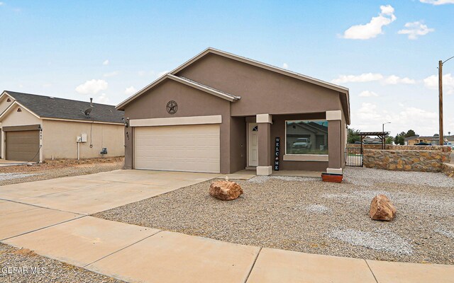 401 Gran Villa Pl, Socorro, TX 79927 - view of front of house featuring stucco siding, a garage, and driveway