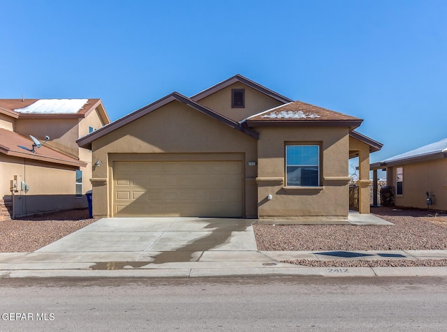 2412 Escape Point St, El Paso, TX 79938 - view of front of house with stucco siding, an attached garage, and driveway