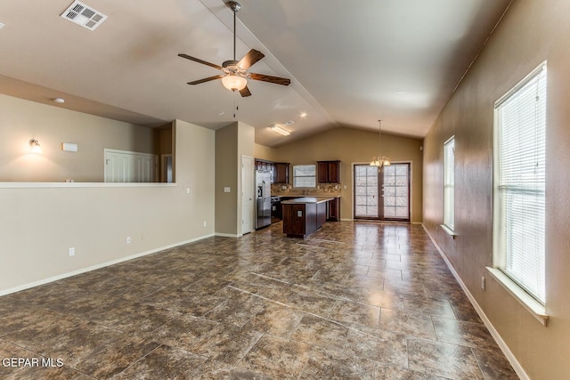 2412 Escape Point St, El Paso, TX 79938 - unfurnished living room with vaulted ceiling, baseboards, ceiling fan, and a chandelier