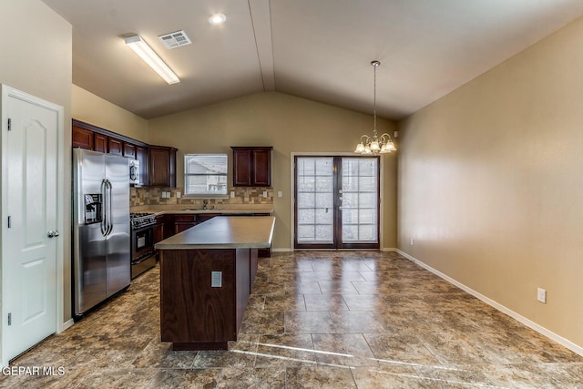 2412 Escape Point St, El Paso, TX 79938 - kitchen with appliances with stainless steel finishes, vaulted ceiling, a chandelier, baseboards, and backsplash