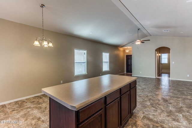 2412 Escape Point St, El Paso, TX 79938 - kitchen with arched walkways, lofted ceiling, a center island, open floor plan, and baseboards