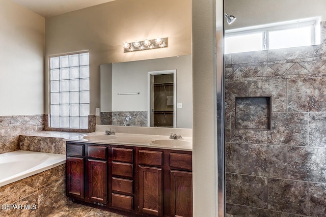 2412 Escape Point St, El Paso, TX 79938 - bathroom with a garden tub, double vanity, tiled shower, and a spacious closet