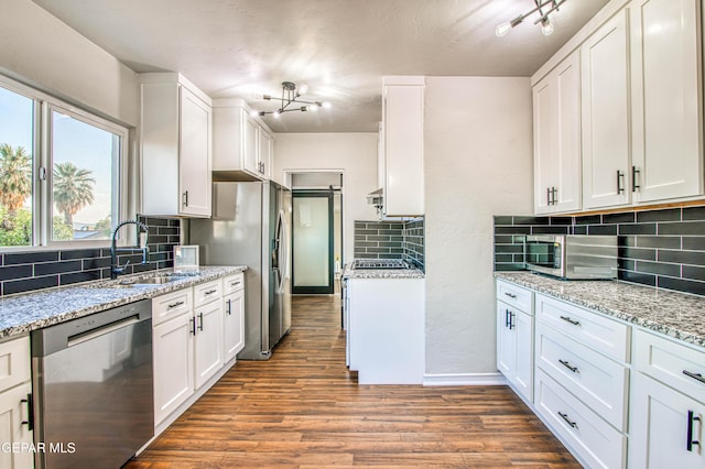 1401 N Boone St, El Paso, TX 79903 - kitchen with stainless steel appliances, a sink, backsplash, and white cabinetry