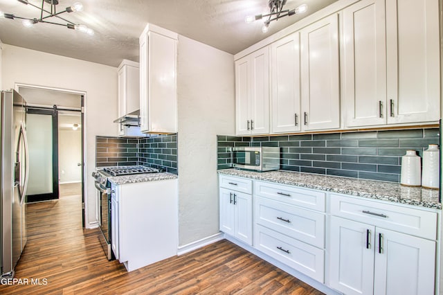 1401 N Boone St, El Paso, TX 79903 - kitchen featuring appliances with stainless steel finishes, dark wood-style floors, baseboards, white cabinetry, and a textured ceiling