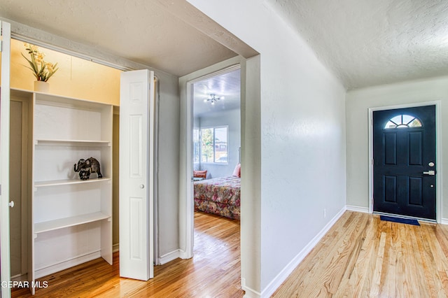 1401 N Boone St, El Paso, TX 79903 - foyer with a textured ceiling, wood finished floors, and baseboards