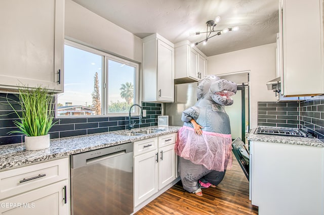 1401 N Boone St, El Paso, TX 79903 - kitchen featuring stainless steel appliances, a sink, dark wood-style floors, decorative backsplash, and white cabinets