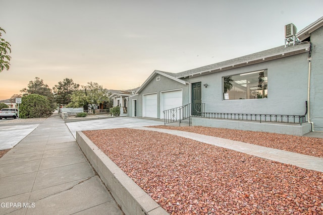 1401 N Boone St, El Paso, TX 79903 - view of front of property with driveway, a garage, and stucco siding