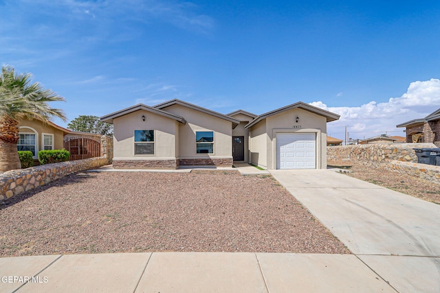 14425 Donny Murray Ln, Horizon City, TX 79928 - ranch-style home with stucco siding, a garage, and concrete driveway