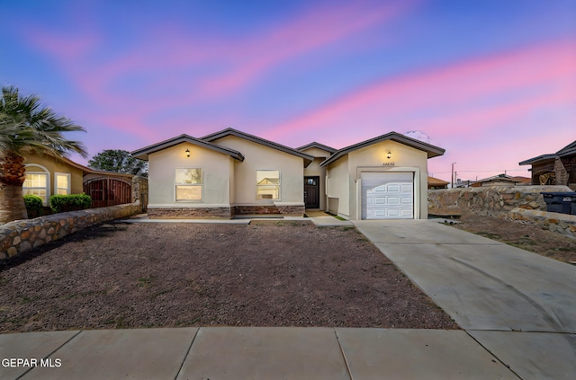 14425 Donny Murray Ln, Horizon City, TX 79928 - single story home featuring stucco siding, a garage, concrete driveway, and stone siding