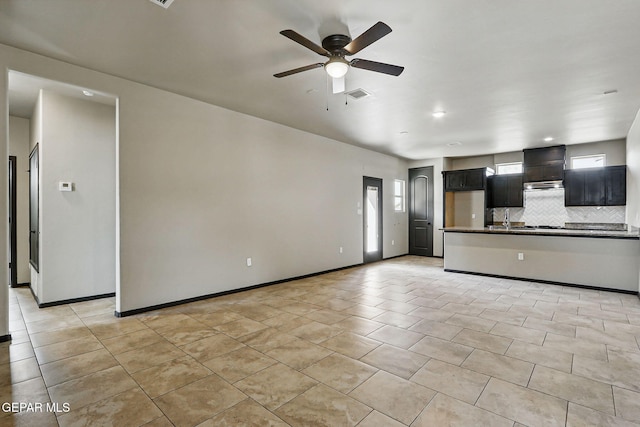 14425 Donny Murray Ln, Horizon City, TX 79928 - unfurnished living room with a ceiling fan, a sink, light tile patterned floors, and baseboards