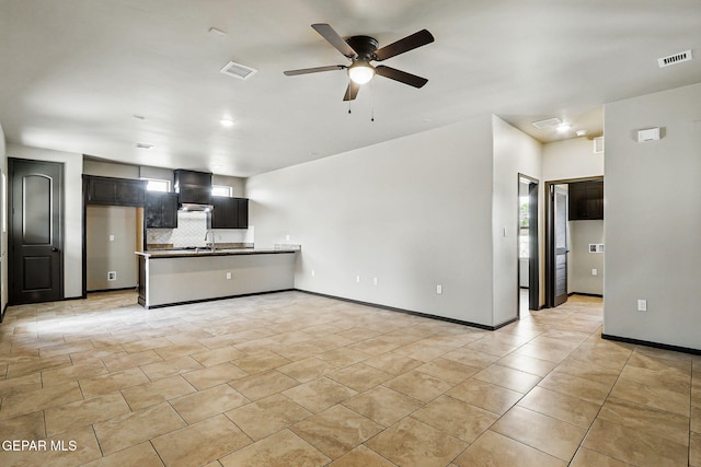 14425 Donny Murray Ln, Horizon City, TX 79928 - unfurnished living room with a ceiling fan, a sink, light tile patterned flooring, and baseboards