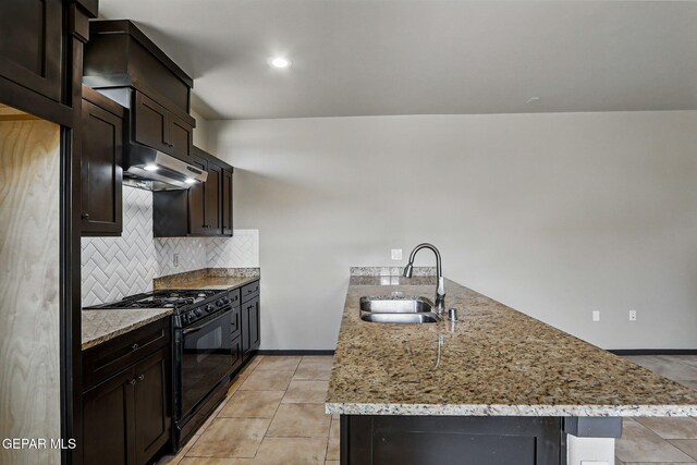14425 Donny Murray Ln, Horizon City, TX 79928 - kitchen featuring black gas stove, a sink, a peninsula, under cabinet range hood, and light stone countertops