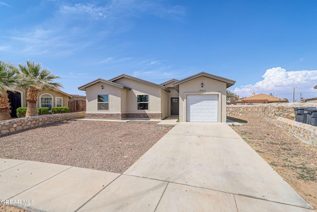 14425 Donny Murray Ln, Horizon City, TX 79928 - ranch-style home featuring stucco siding, an attached garage, concrete driveway, and stone siding