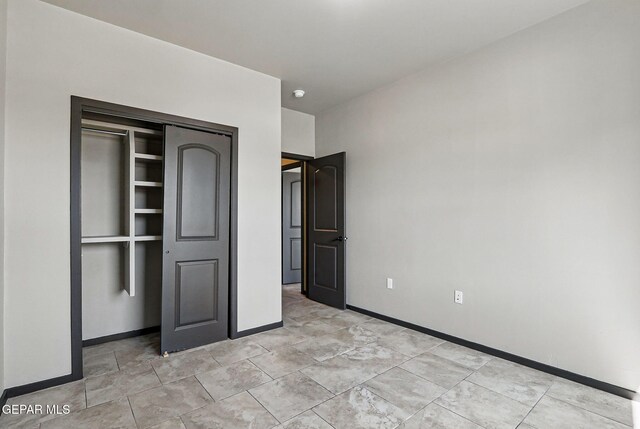 14425 Donny Murray Ln, Horizon City, TX 79928 - unfurnished bedroom featuring baseboards and a closet