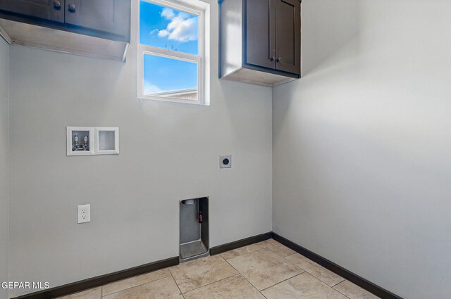 14425 Donny Murray Ln, Horizon City, TX 79928 - washroom with cabinet space, electric dryer hookup, hookup for a washing machine, baseboards, and light tile patterned floors