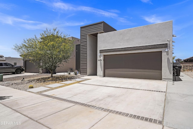 13579 Lawkland St, Horizon City, TX 79928 - contemporary house with driveway, stucco siding, and a garage