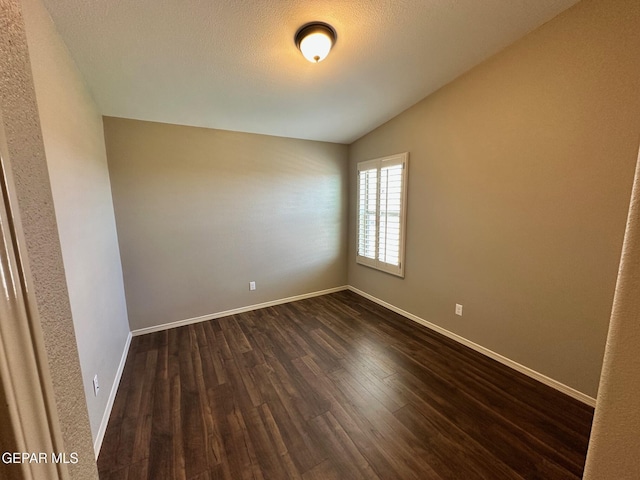 7217 Long Meadow Dr, El Paso, TX 79934 - empty room with lofted ceiling, dark wood-type flooring, and baseboards