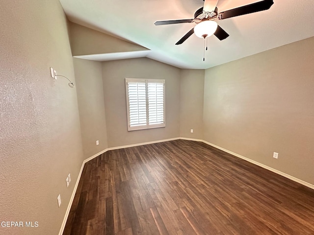 7217 Long Meadow Dr, El Paso, TX 79934 - spare room featuring dark wood-style floors, vaulted ceiling, ceiling fan, and baseboards
