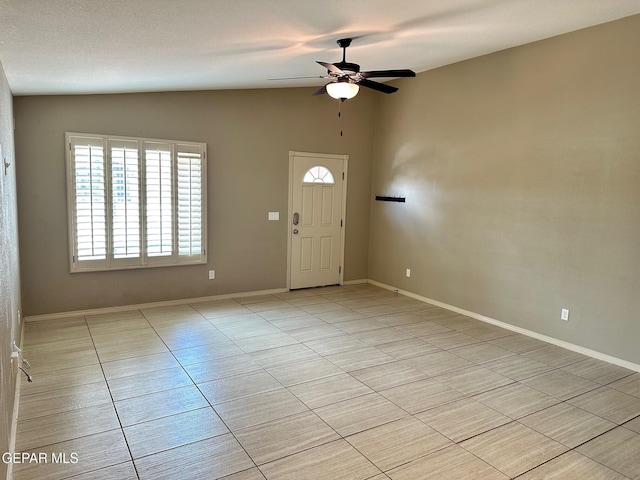 7217 Long Meadow Dr, El Paso, TX 79934 - foyer entrance with vaulted ceiling, light tile patterned floors, ceiling fan, and baseboards