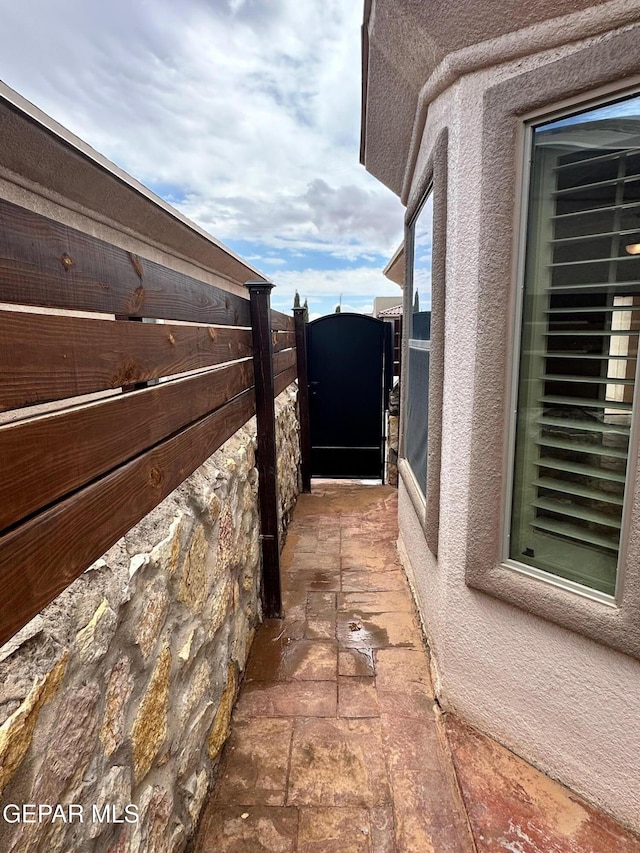 7217 Long Meadow Dr, El Paso, TX 79934 - view of side of property with a gate and stucco siding