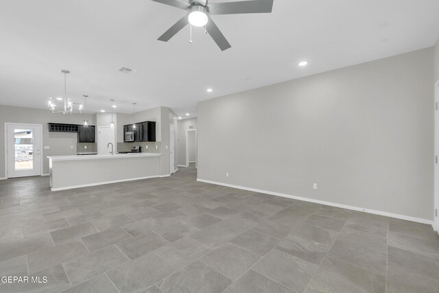 12169 Sanna Dr, El Paso, TX 79934 - unfurnished living room featuring a chandelier, a ceiling fan, a sink, recessed lighting, and baseboards