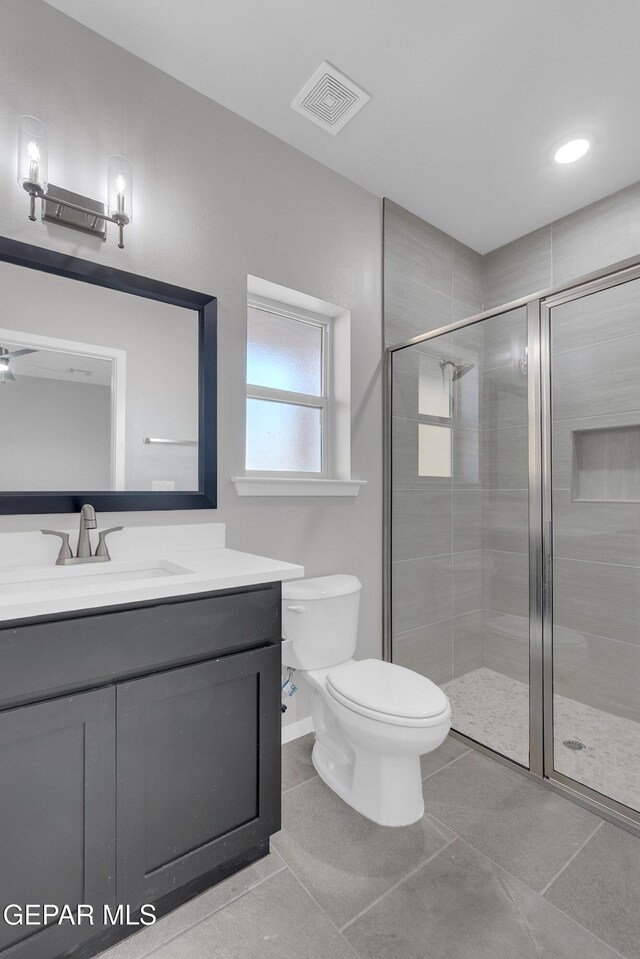 12169 Sanna Dr, El Paso, TX 79934 - full bath featuring vanity, toilet, a stall shower, tile patterned flooring, and baseboards
