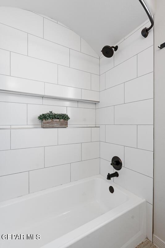 3809 Plan Pl, El Paso, TX 79938 - bathroom featuring vaulted ceiling and  shower combination