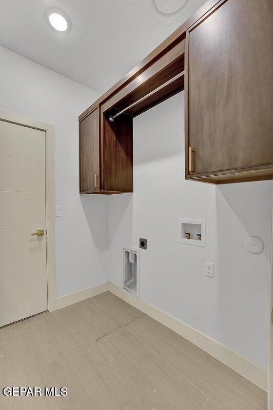 12748 Polo Norte Dr, El Paso, TX 79934 - washroom featuring cabinet space, hookup for a washing machine, and hookup for an electric dryer