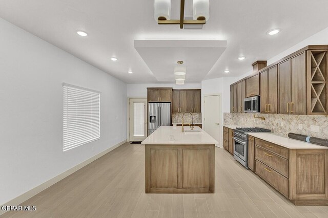 12748 Polo Norte Dr, El Paso, TX 79934 - kitchen with stainless steel appliances, decorative backsplash, light wood-style flooring, light countertops, and recessed lighting