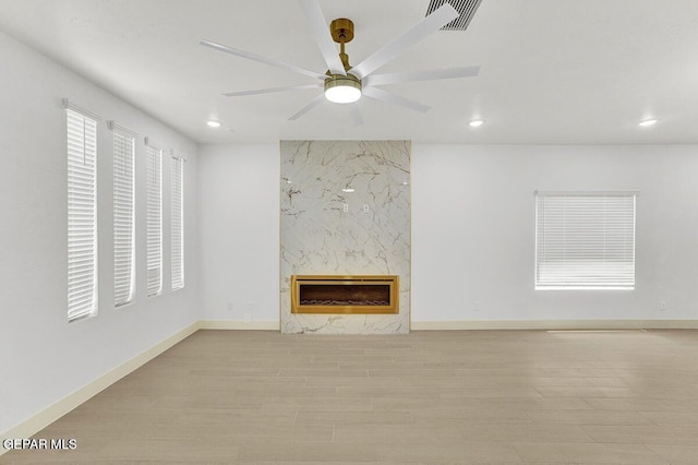 12748 Polo Norte Dr, El Paso, TX 79934 - unfurnished living room featuring recessed lighting, heating unit, wood finished floors, a ceiling fan, and a high end fireplace