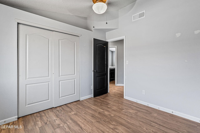11912 Mesquite Miel Dr, El Paso, TX 79938 - unfurnished bedroom featuring wood finished floors, baseboards, a closet, vaulted ceiling, and ceiling fan