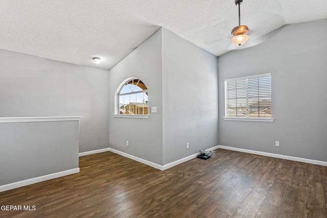 11912 Mesquite Miel Dr, El Paso, TX 79938 - empty room featuring wood finished floors, a textured ceiling, baseboards, and vaulted ceiling