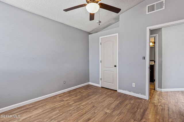 11912 Mesquite Miel Dr, El Paso, TX 79938 - unfurnished bedroom with vaulted ceiling, wood finished floors, a textured ceiling, baseboards, and a ceiling fan