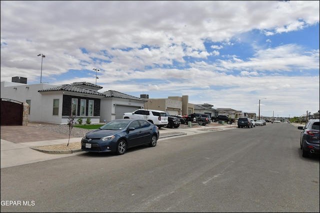 13106 Cleethorpes St, El Paso, TX 79928 - view of asphalt road with sidewalks, street lighting, and curbs