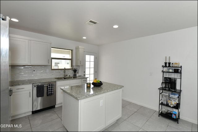 13106 Cleethorpes St, El Paso, TX 79928 - kitchen featuring dishwasher, a sink, a center island, light stone countertops, and decorative backsplash