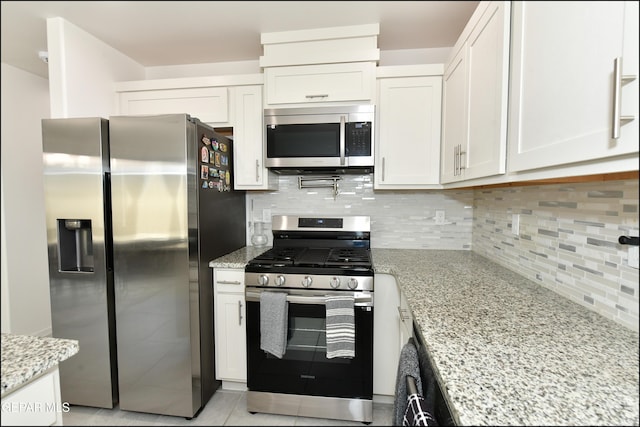 13106 Cleethorpes St, El Paso, TX 79928 - kitchen with stainless steel appliances, white cabinetry, backsplash, and light stone counters
