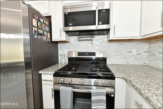 13106 Cleethorpes St, El Paso, TX 79928 - kitchen with stainless steel appliances, white cabinets, and tasteful backsplash