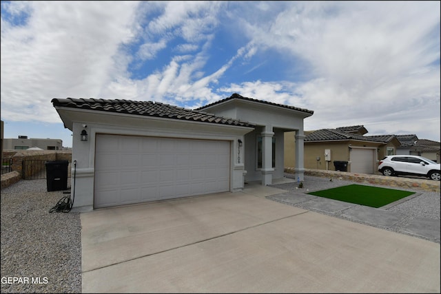13106 Cleethorpes St, El Paso, TX 79928 - mediterranean / spanish-style house with concrete driveway, an attached garage, a tiled roof, and stucco siding