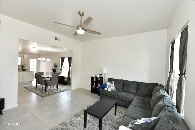 13106 Cleethorpes St, El Paso, TX 79928 - living area featuring light tile patterned flooring, a ceiling fan, a chandelier, and baseboards