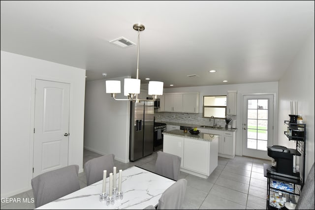 13106 Cleethorpes St, El Paso, TX 79928 - kitchen featuring stainless steel appliances, a sink, a center island, tasteful backsplash, and light stone countertops