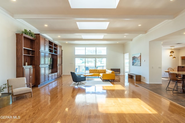 1013 Singing Hills Dr, El Paso, TX 79912 - living room with light wood finished floors, ornamental molding, a skylight, baseboards, and recessed lighting