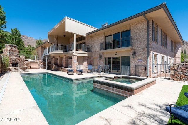 1013 Singing Hills Dr, El Paso, TX 79912 - view of swimming pool featuring a patio area, a fireplace, stairs, and a pool with connected hot tub
