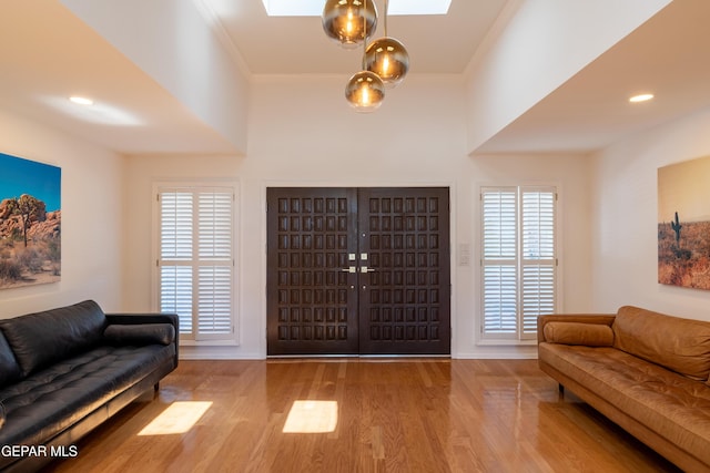 1013 Singing Hills Dr, El Paso, TX 79912 - foyer entrance with wood finished floors, a skylight, baseboards, and ornamental molding