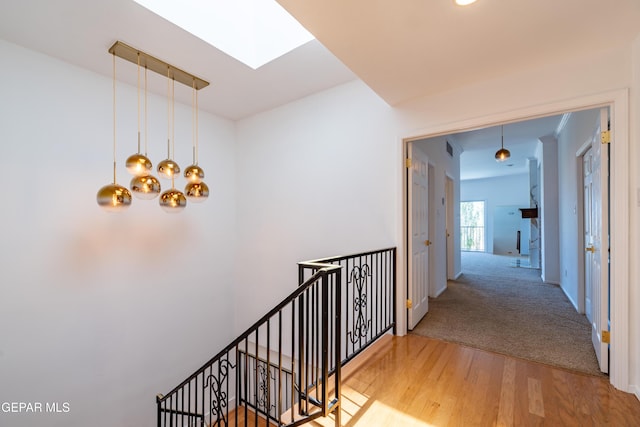 1013 Singing Hills Dr, El Paso, TX 79912 - hallway with a skylight, a chandelier, wood finished floors, and an upstairs landing