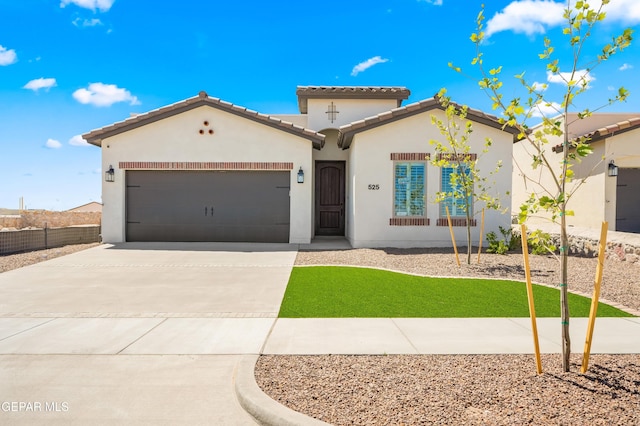 14924 Hill Ridge Ct, El Paso, TX 79938 - mediterranean / spanish-style home with concrete driveway, stucco siding, a garage, and a tile roof