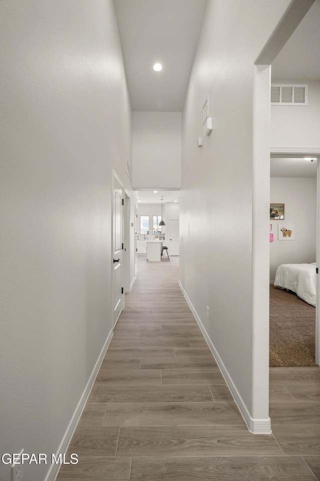 14932 Hill Ridge Ct, El Paso, TX 79938 - corridor with wood finished floors, baseboards, a high ceiling, and recessed lighting