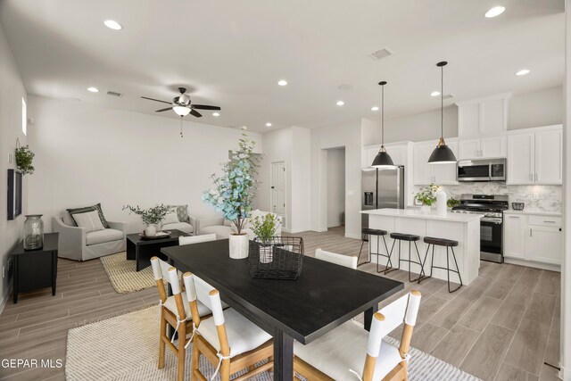 14932 Hill Ridge Ct, El Paso, TX 79938 - dining room with wood tiled floors, ceiling fan, recessed lighting, and baseboards